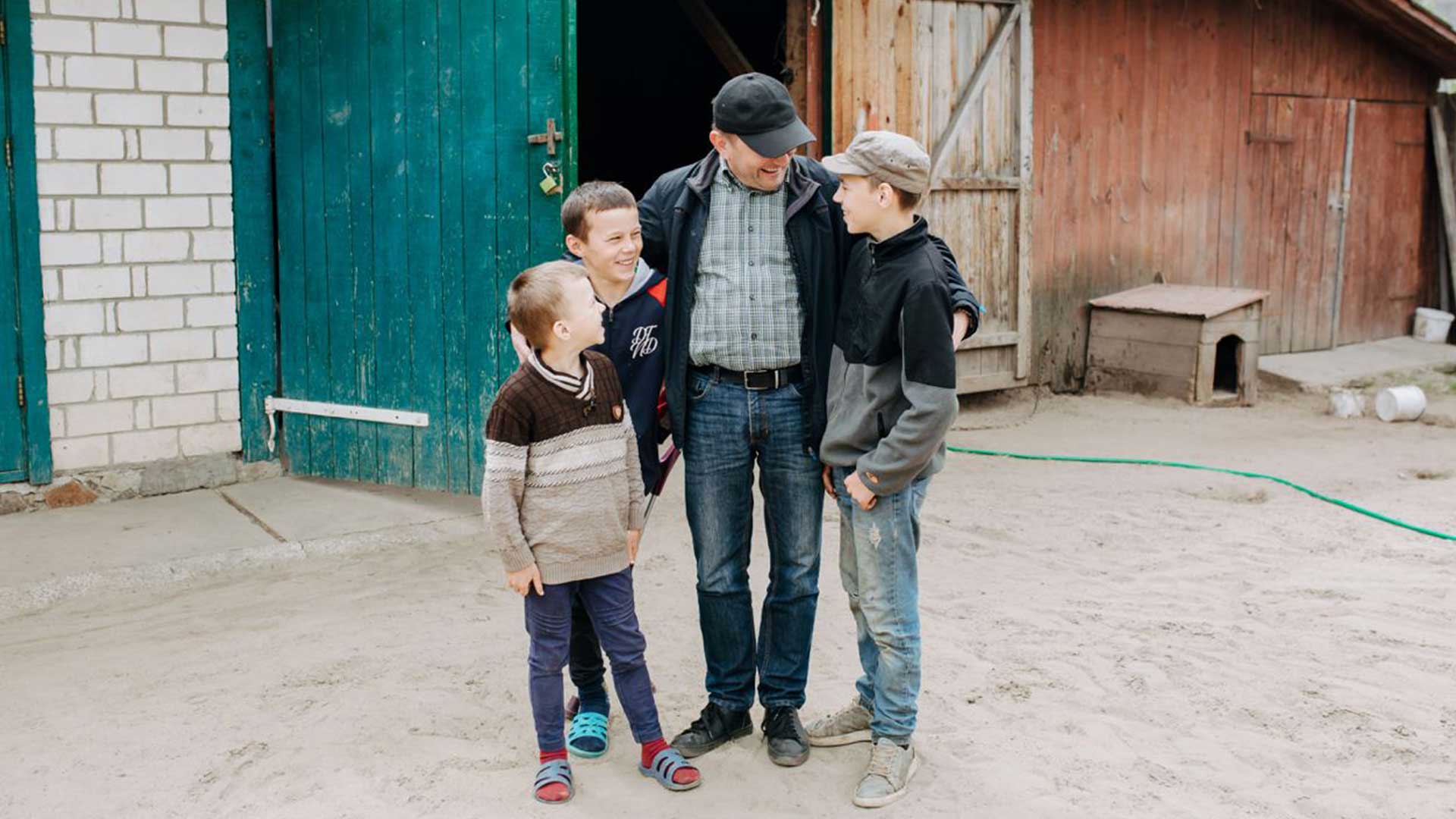 A coordinator stood with three young boys