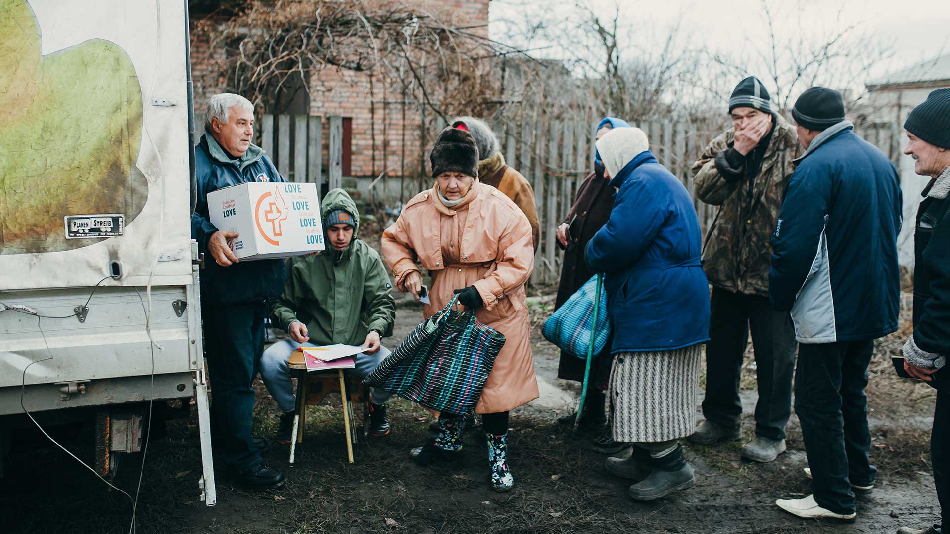 People receive boxes of supplies, Ukraine.